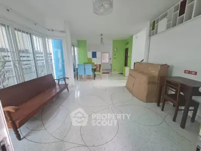 Spacious living room with modern decor and large windows for natural light.