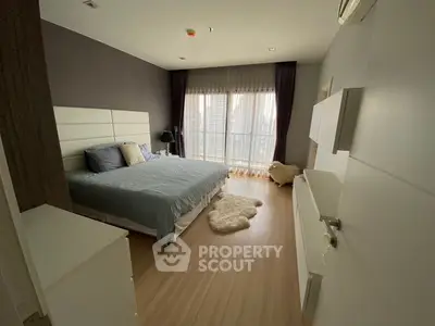 Spacious modern bedroom with large windows and stylish decor