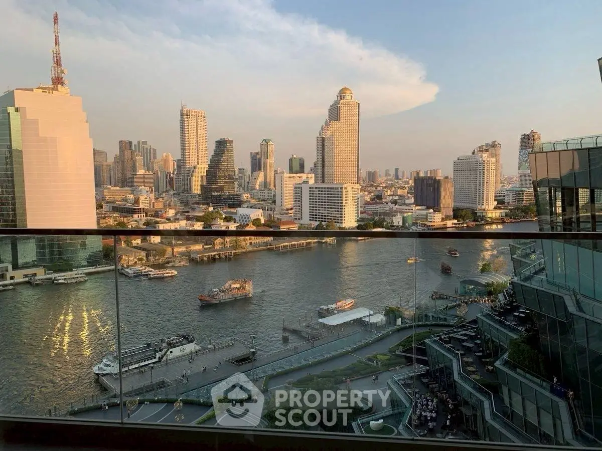 Stunning riverfront cityscape view from a high-rise balcony at sunset, showcasing urban skyline.
