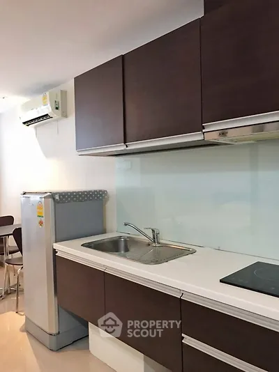 Modern kitchen with sleek cabinets and built-in appliances in a stylish apartment.
