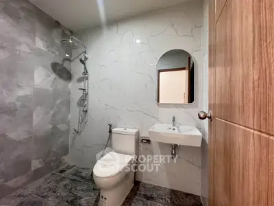 Modern bathroom with marble tiles and sleek fixtures in a contemporary home.
