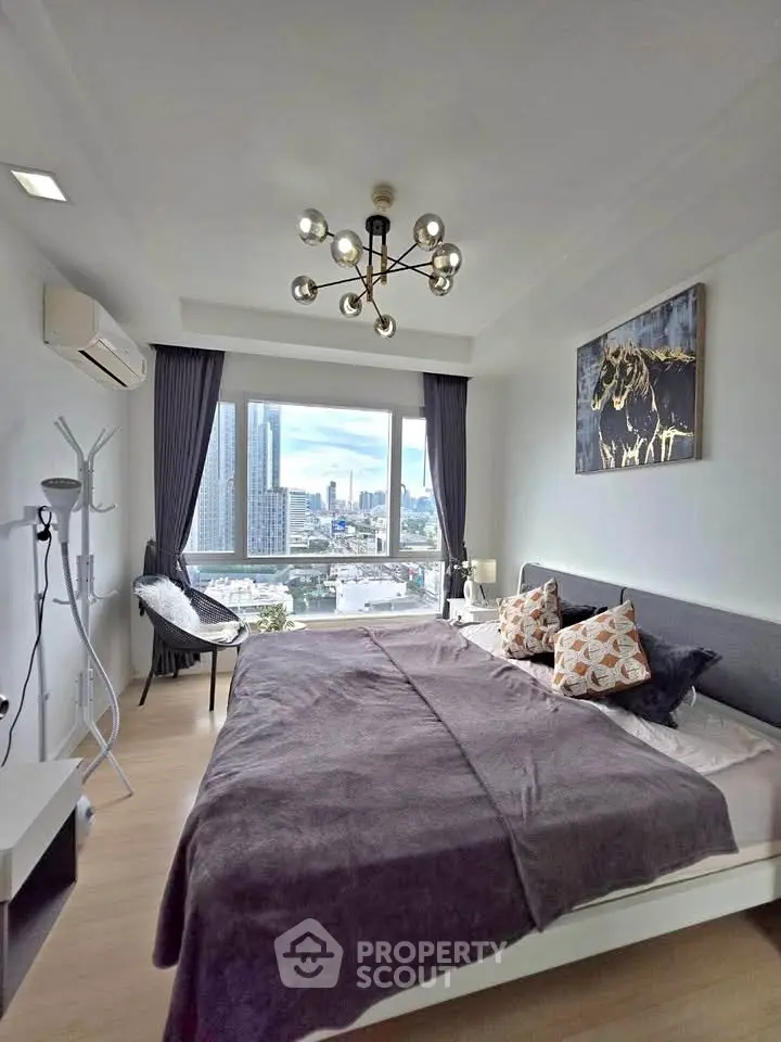 Modern bedroom with city view, stylish decor, and natural light