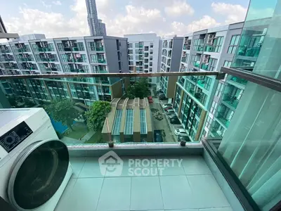 Modern apartment balcony with city view and washing machine, perfect for urban living.