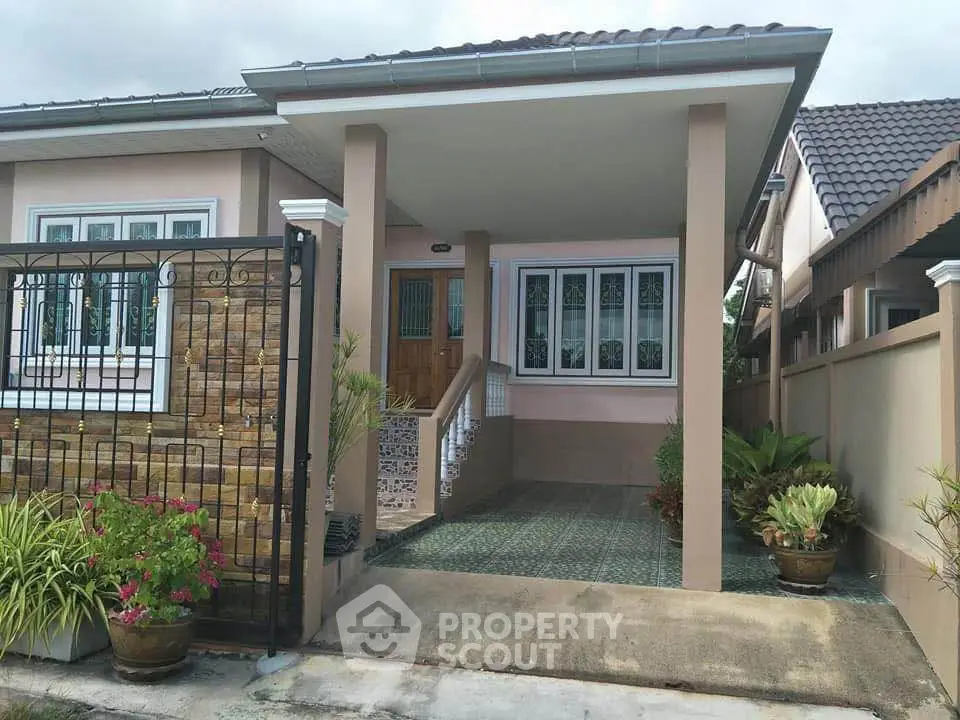 Charming single-story home with gated entrance and lush garden