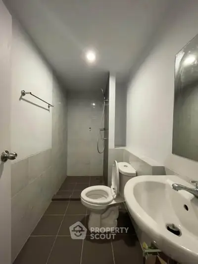 Modern bathroom with sleek design and walk-in shower in a contemporary apartment.