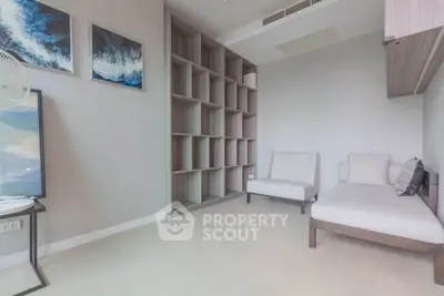 Modern minimalist living room with built-in shelving and cozy seating area.