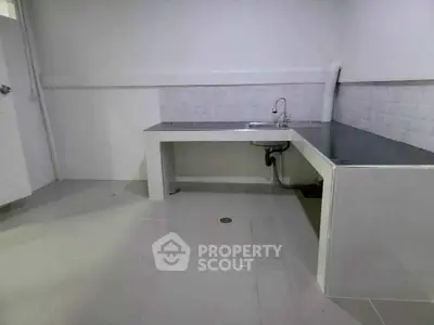 Minimalist kitchen with sleek countertops and modern sink design