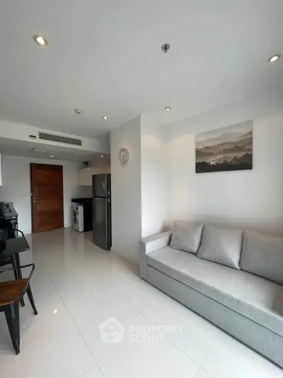 Modern living room with sleek design and integrated kitchen appliances