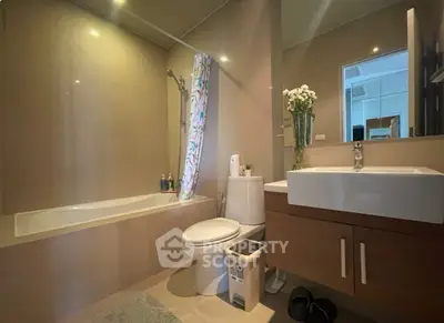 Modern bathroom with bathtub and sleek vanity in a stylish apartment.