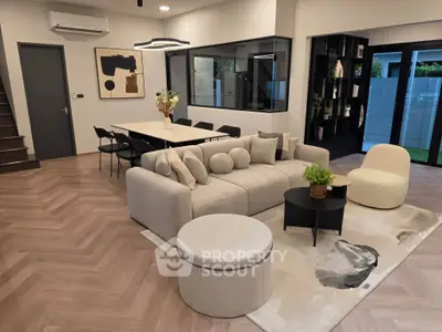 Modern living room with stylish furniture and open layout, featuring a cozy sofa and elegant decor.