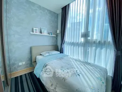 Bright and cozy bedroom with large windows and modern decor