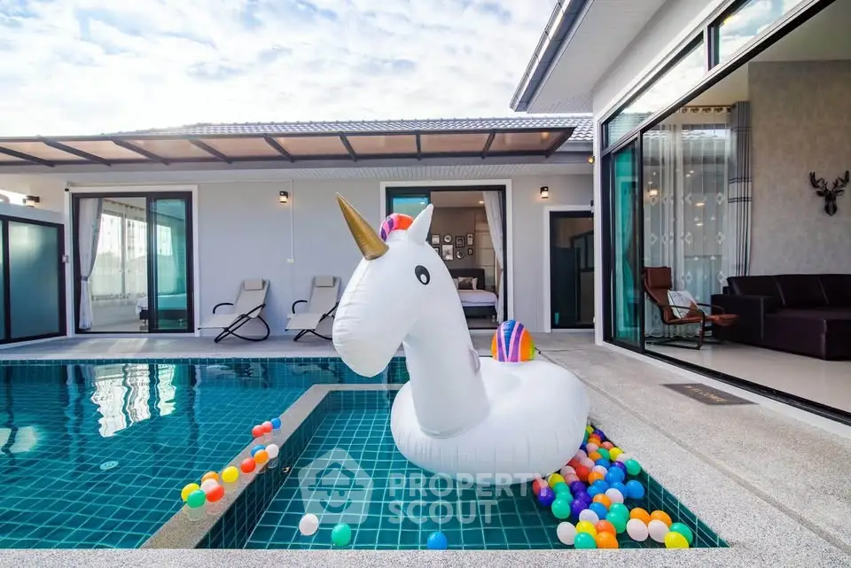 Luxurious villa with private pool and playful unicorn float, perfect for family getaways.