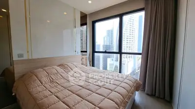 Modern bedroom with city view in high-rise apartment