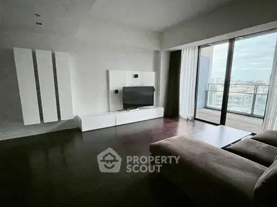 Spacious living room with modern decor and large balcony view