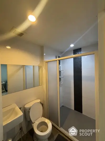 Modern bathroom with shower enclosure and sleek fixtures