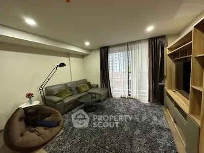 Spacious living room with modern decor and large window for natural light.