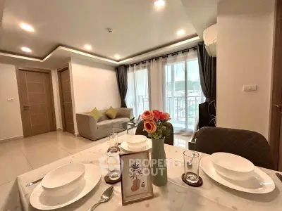 Elegant living room with dining area and balcony view in modern apartment.