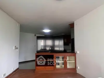 Spacious living room with built-in wooden cabinet and open layout