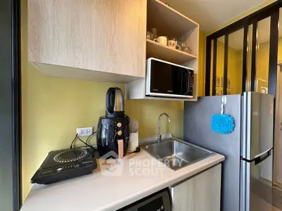Modern compact kitchen with sleek appliances and open shelving