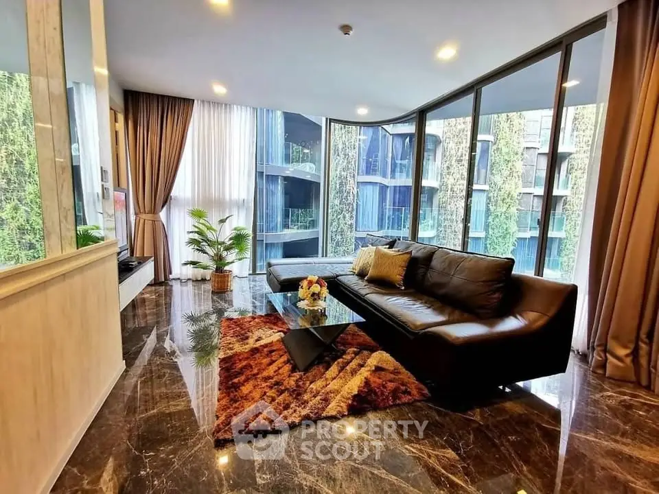 Luxurious living room with floor-to-ceiling windows and modern decor in a high-end apartment.