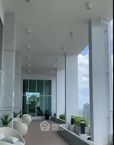 Luxurious high-rise balcony with stunning city views and modern seating area.