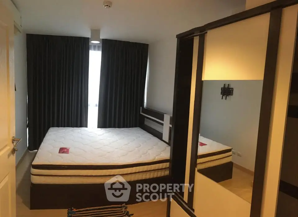 Spacious bedroom with large bed and modern wardrobe in a cozy apartment.