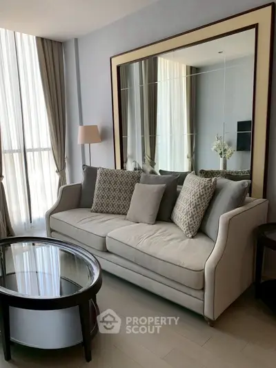 Elegant living room with stylish sofa and large mirror, perfect for modern interiors.