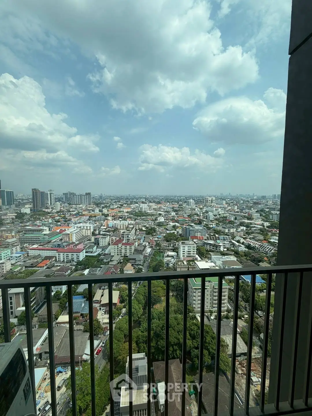 Stunning cityscape view from a high-rise balcony, showcasing urban skyline and expansive horizon.