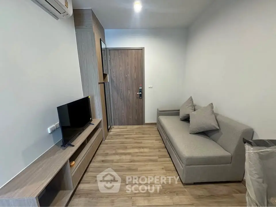 Modern living room with sleek furniture and wooden flooring