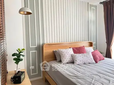 Charming bedroom with stylish decor and natural light, featuring a cozy bed and elegant wall design.