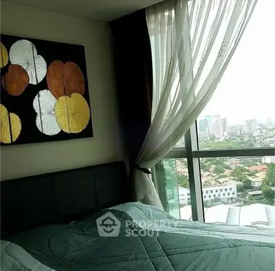 Modern bedroom with large window offering stunning city view and elegant decor.
