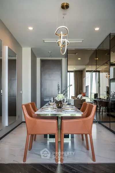 Elegant dining area with modern lighting and leather chairs in luxury apartment