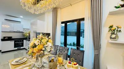 Luxurious dining area with elegant decor and modern kitchen in open layout