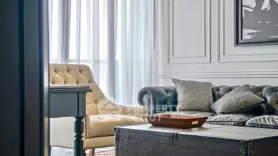 Elegant living room with classic sofa and armchair, perfect for luxury home decor.