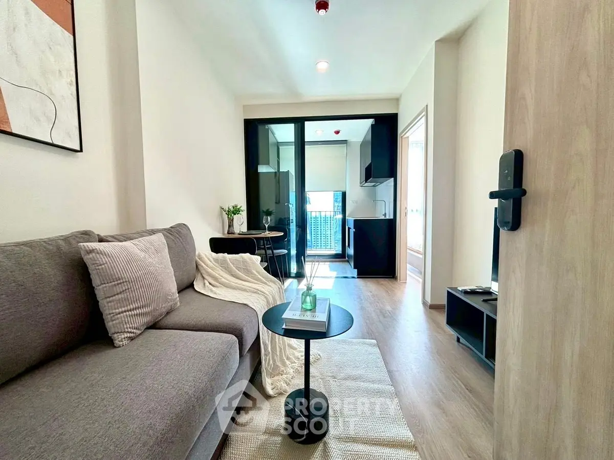 Modern living room with stylish decor and open kitchen layout in a contemporary apartment.
