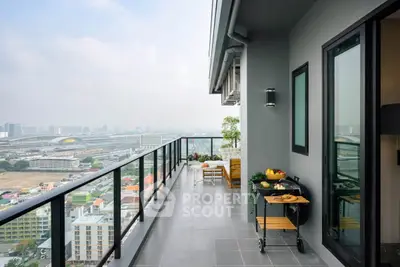 Stunning high-rise balcony with panoramic city views and modern outdoor decor.