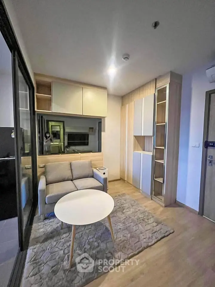 Modern living room with cozy sofa, stylish storage, and elegant decor in a contemporary apartment.