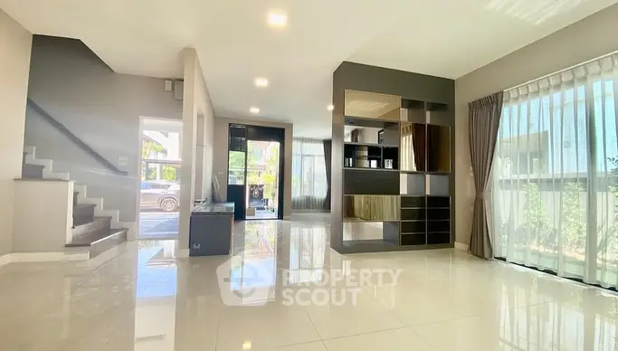 Spacious modern living room with large windows and sleek design