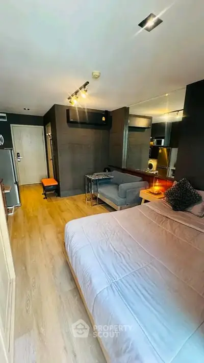 Modern studio apartment with cozy living area and stylish decor