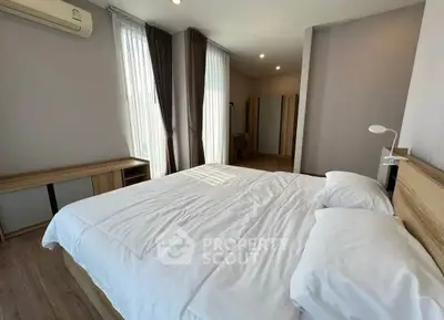 Spacious bedroom with modern decor and natural light
