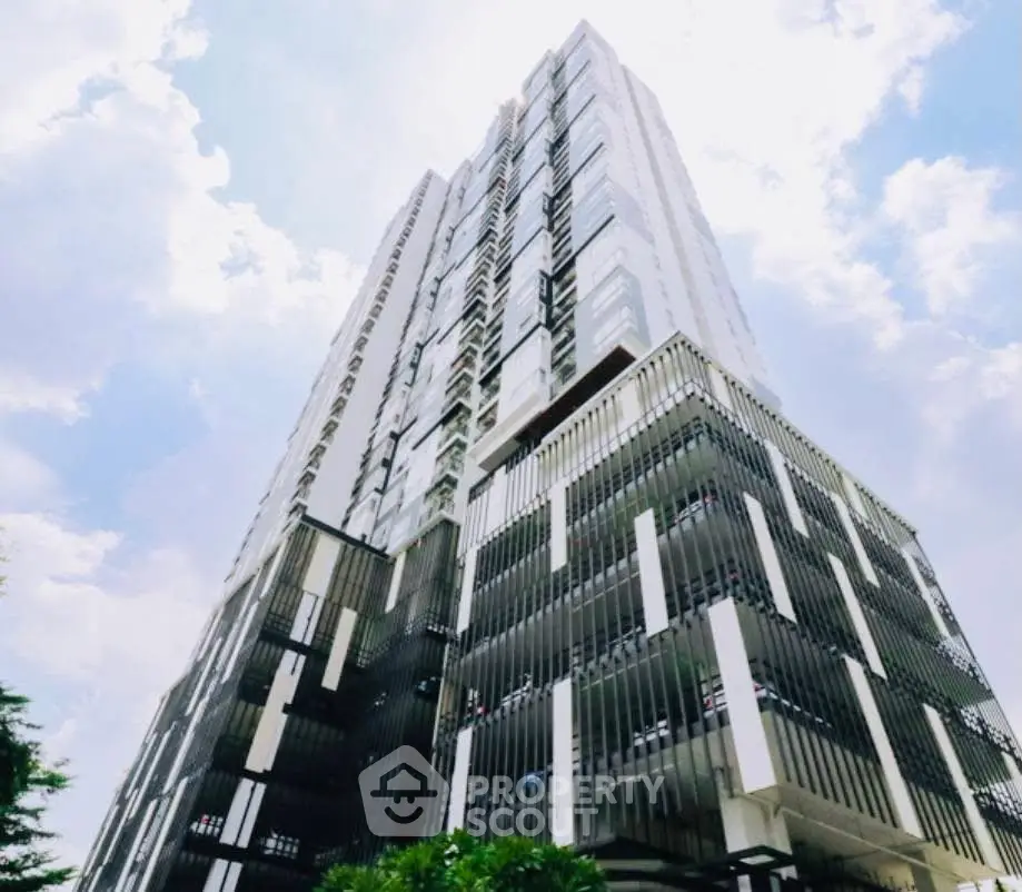 Stunning modern high-rise building with sleek architectural design against a bright sky.