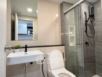 Modern bathroom with sleek shower and elegant fixtures in a contemporary apartment.