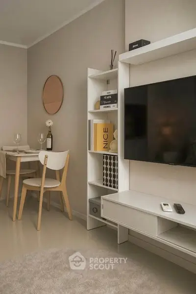Modern living room with sleek TV unit and cozy dining area, perfect for urban living.