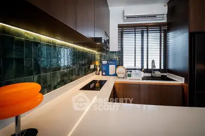 Modern kitchen with sleek design, featuring induction cooktop and stylish cabinetry.
