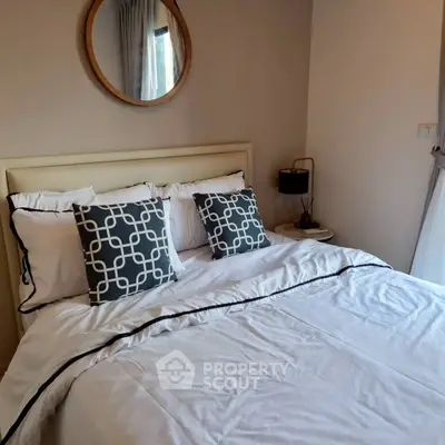 Cozy bedroom with stylish decor and comfortable bedding, perfect for relaxation.