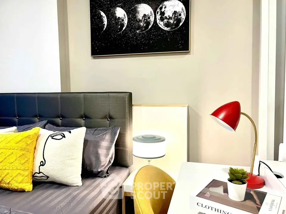 Stylish bedroom with modern decor, featuring a cozy bed, chic artwork, and a functional study area.