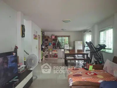 Spacious living room with modern decor and exercise equipment, perfect for relaxation and entertainment.