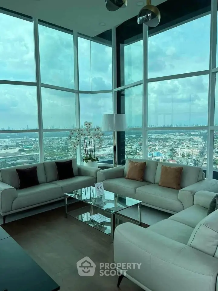 Luxurious corner unit living room with panoramic city views and elegant furnishings.