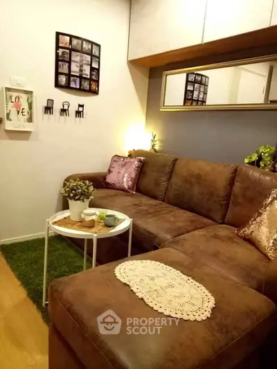 Cozy living room with brown leather sofa and decorative wall art