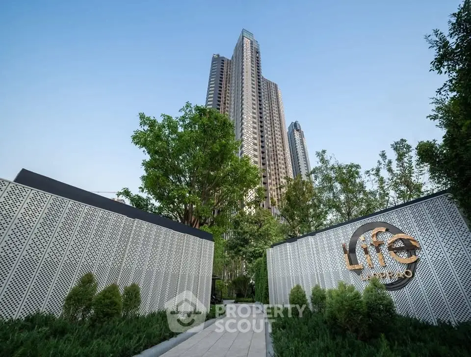 Stunning high-rise building with lush greenery and modern design entrance